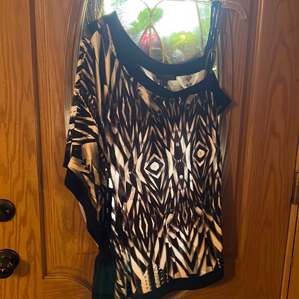 Neat top, one side has spaghetti strap while yeh other has partial sleeve